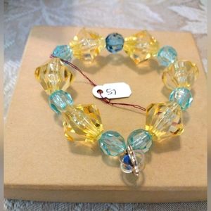 Artemis's Gems custom-made beaded bracelet with pale blue and gold beads/charm